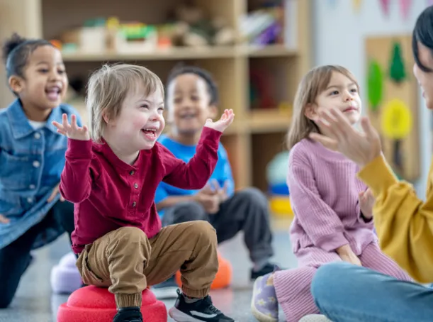 Child with Down Syndrome participating in circle time with his friends