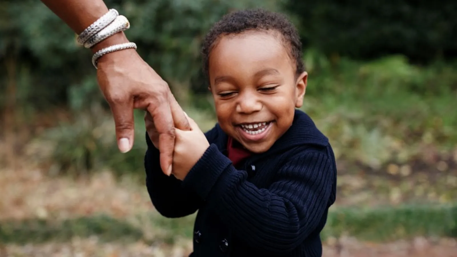 Teacher holding child's hand
