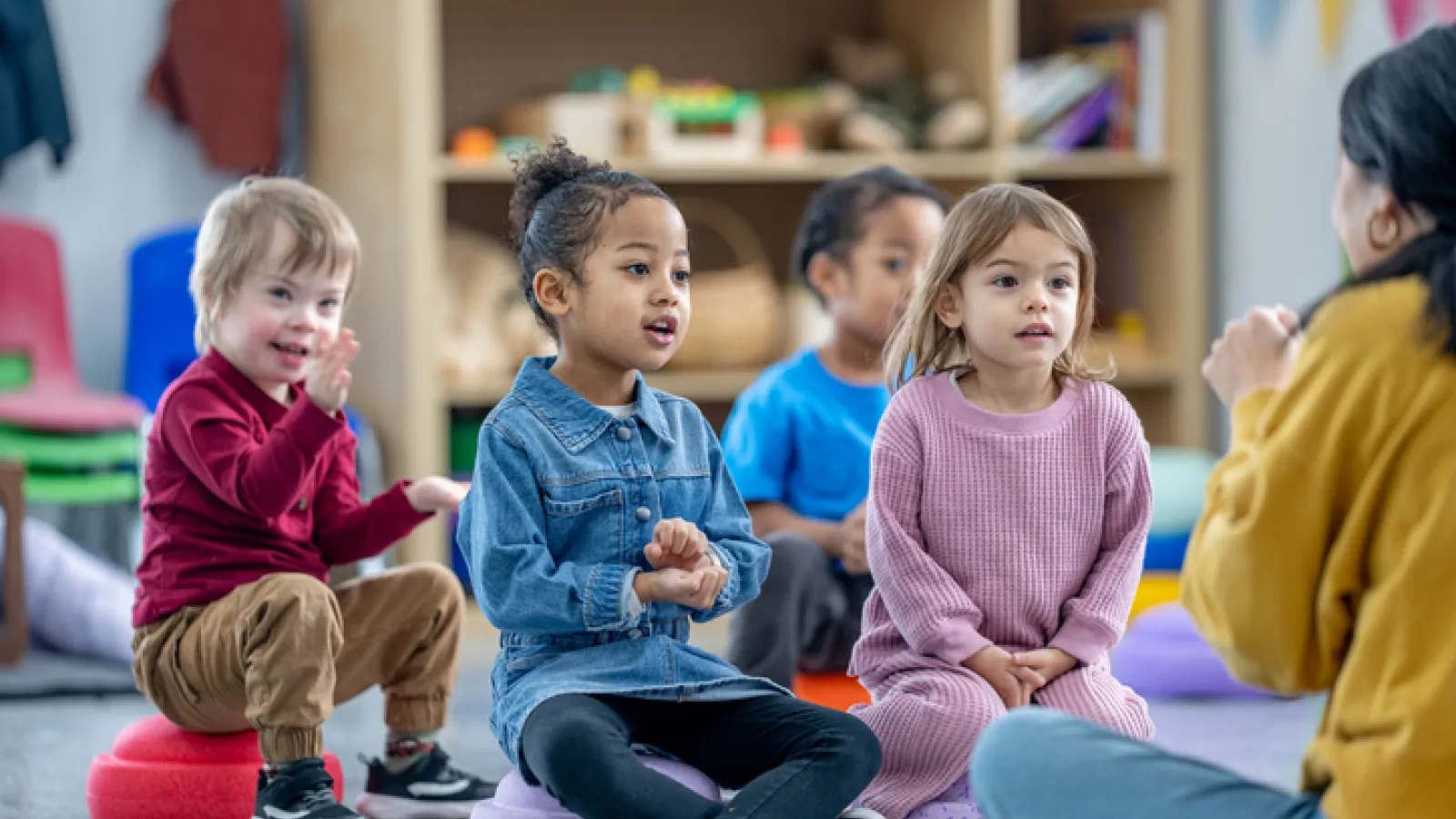 Group of young children in an early childhood classroom including a child with a disability.