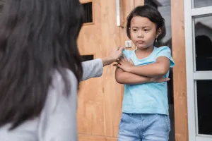 Young girl with arms crossed and looking upset