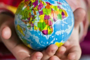 A small globe in a young child's hands