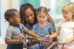 Teacher reading with 3 children