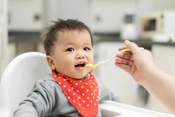 Boy being fed baby food with spoon